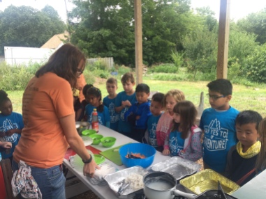 Youth Educator, Christine, shows the kids how to make Spring Rolls!